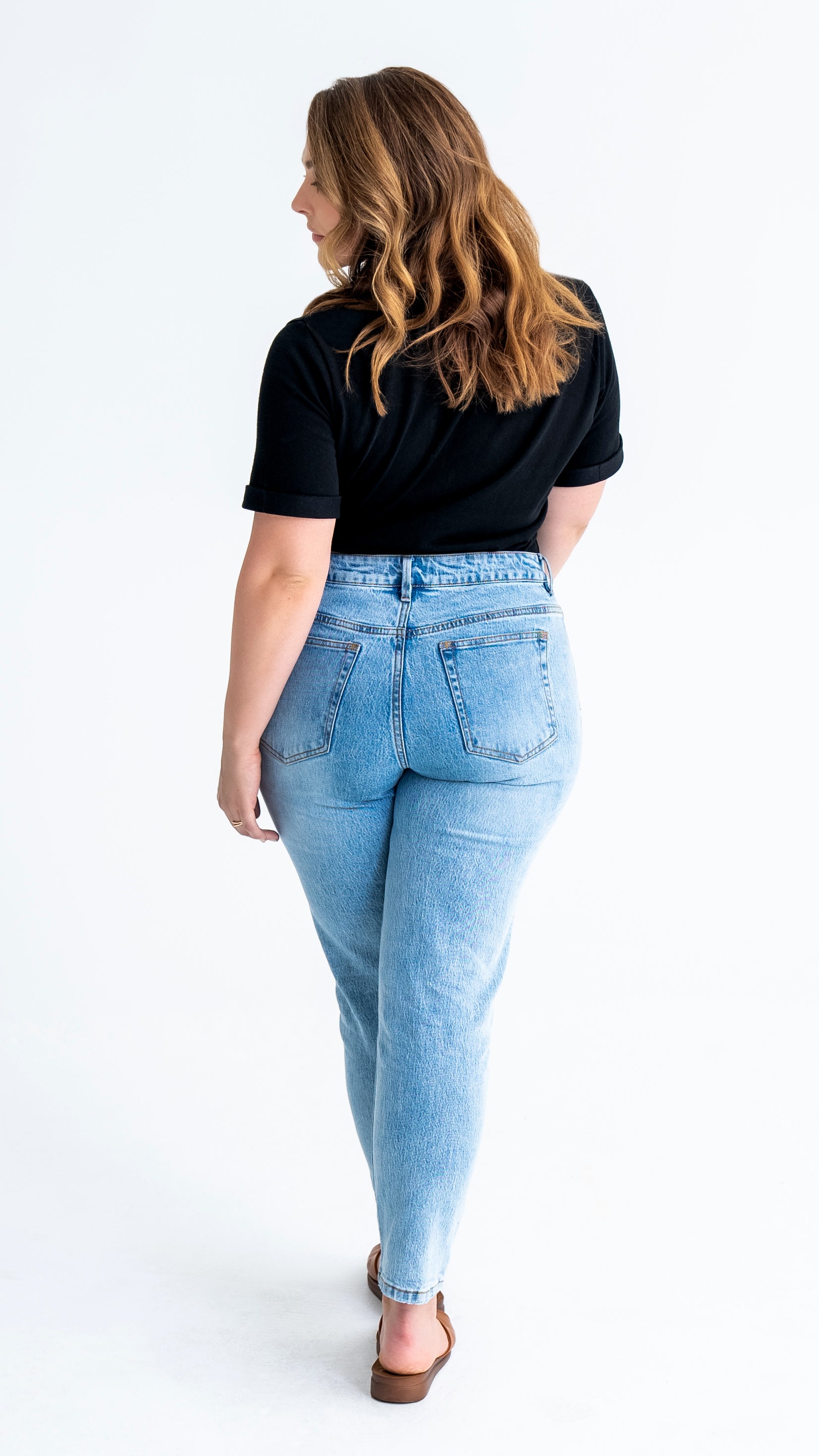 Full length back view of pear-shaped jeans in washed blue colour.  Model wears size 12 in average length.