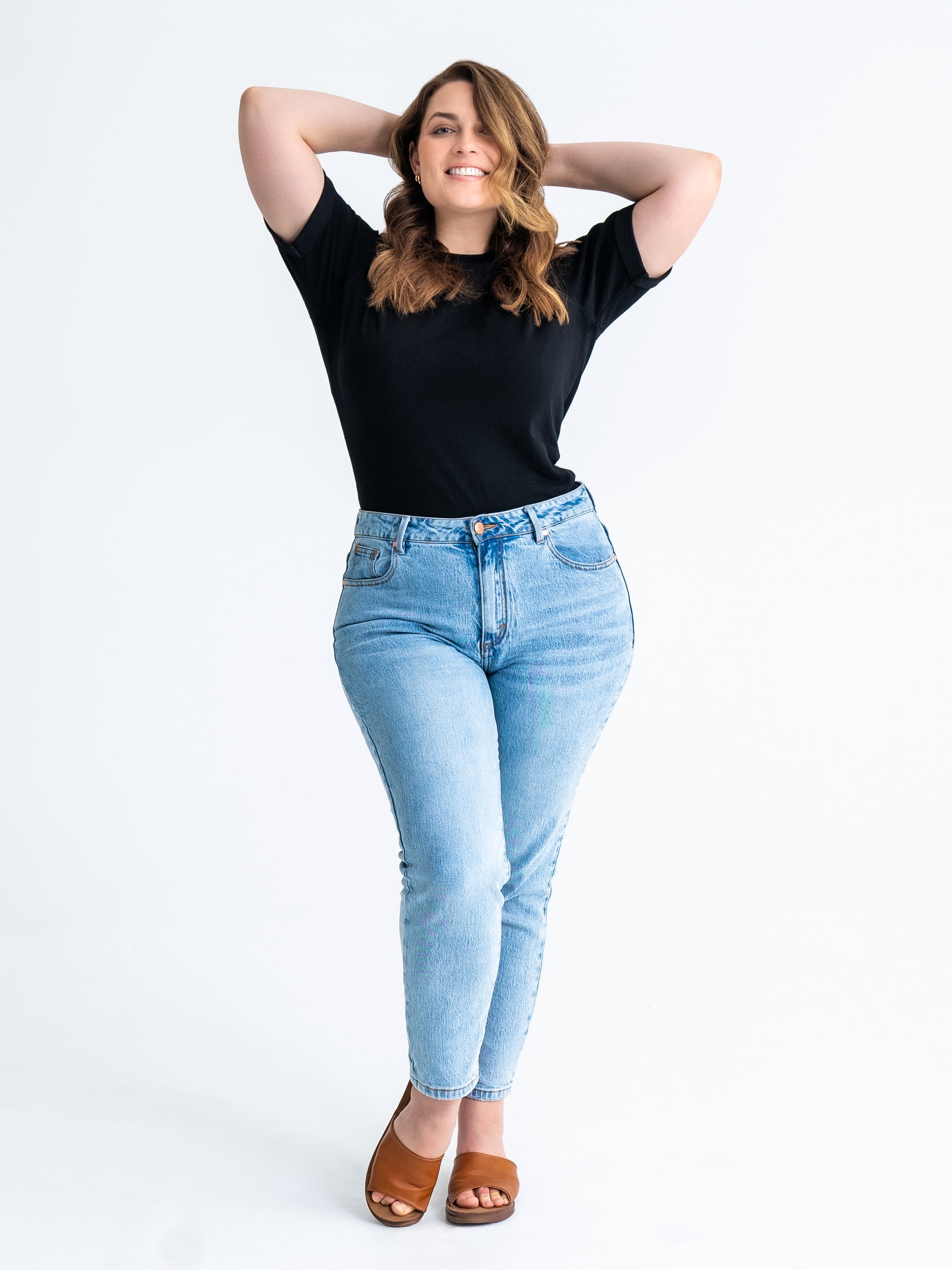 Full length, front-on view of pear shaped jeans in washed blue colour. Model wears size 12 in average length.